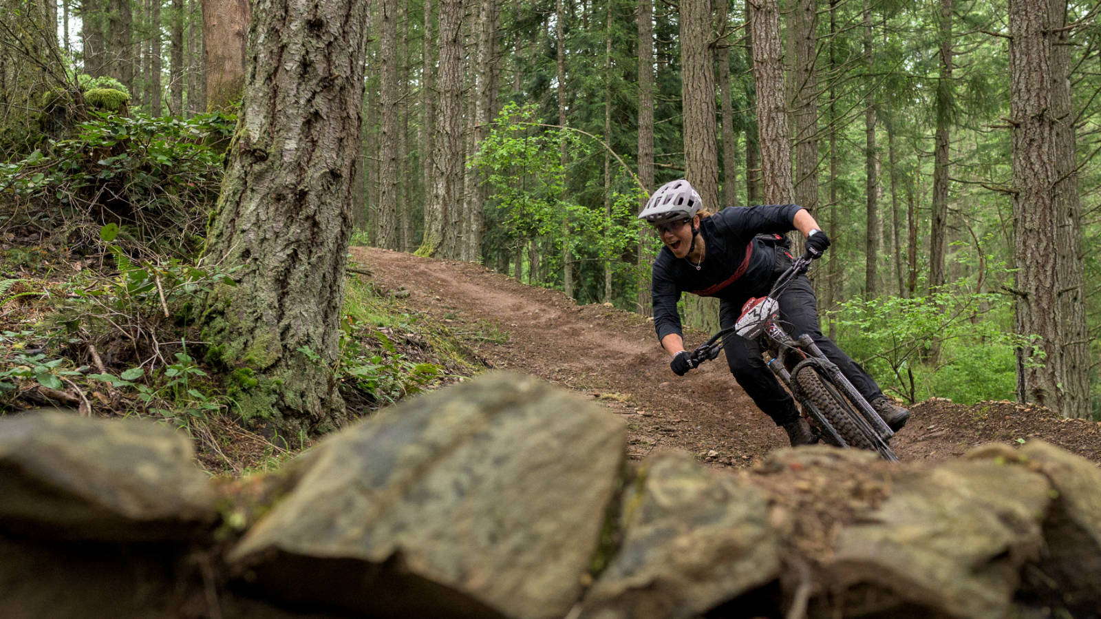 woman riding a berm while mountain biking