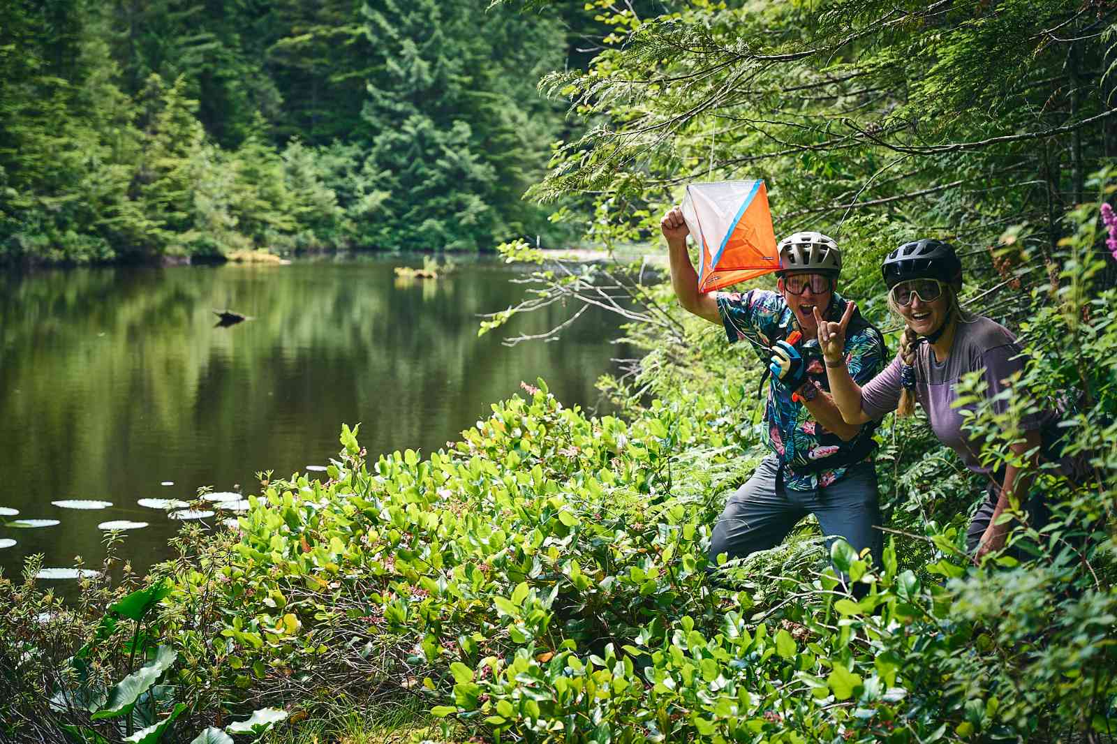 Two people find an orienteering flag as part of the MegaVolt Trailforks Adventure Challenge